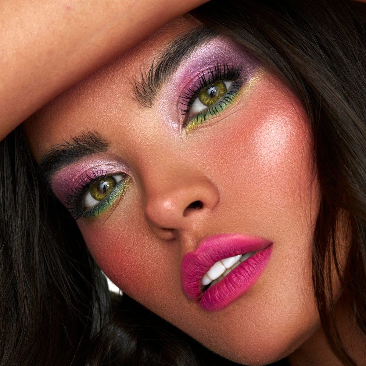 A finished glam look — graphic pink and green eye.
